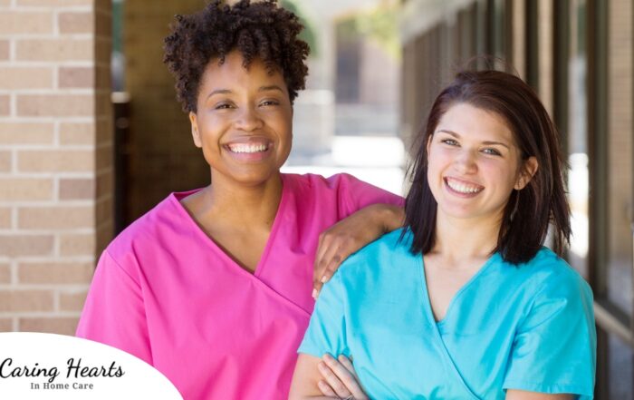 2 smiling women in scrubs represent RN supervisors and the good environment that can be promoted when they work together with caregivers for quality client care.