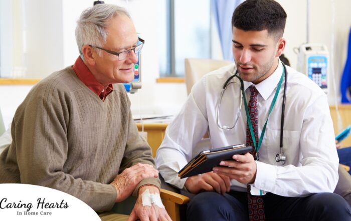 An older man talks with a doctor representing the effective communication that family caregivers should endeavor to have.