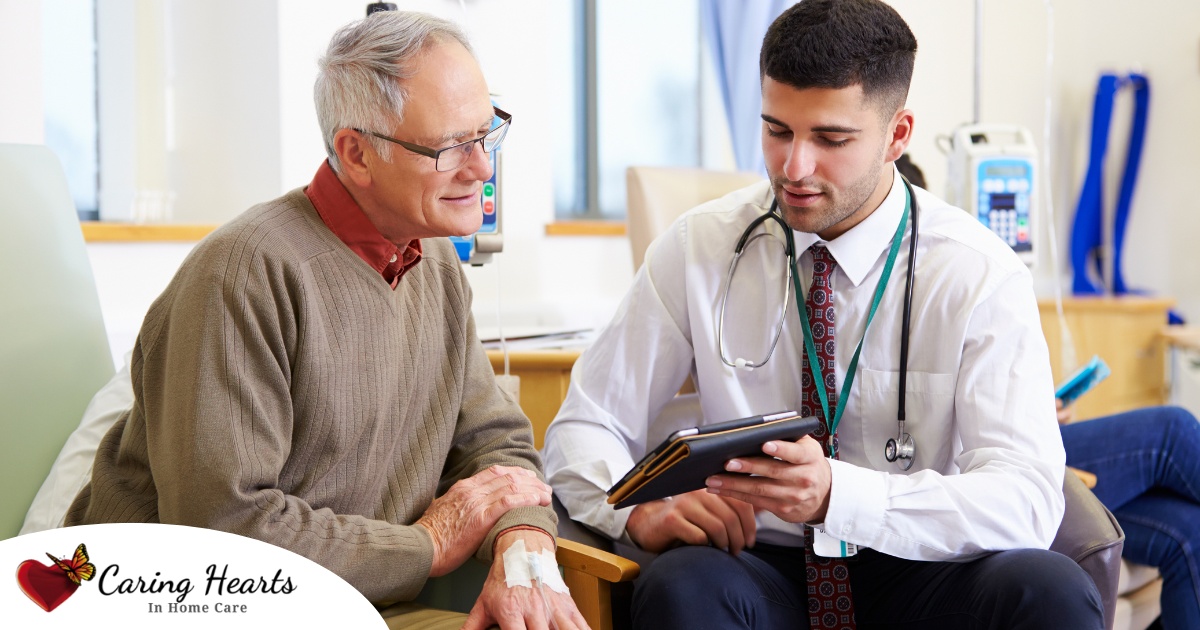 An older man talks with a doctor representing the effective communication that family caregivers should endeavor to have.